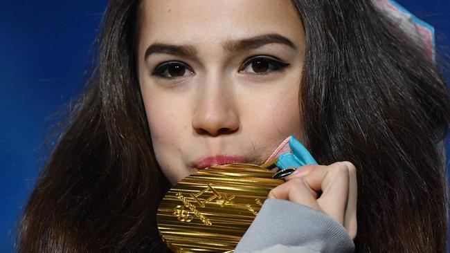 Russia's gold medallist Alina Zagitova kisses her medal on the podium during the medal ceremony for the figure skating women's singles.