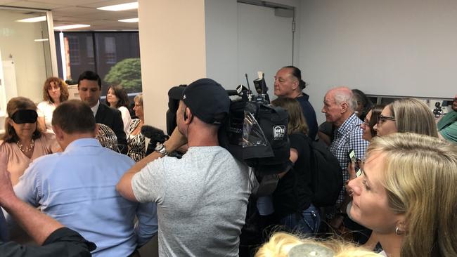 Mr Abbott secured prime position for the draw (blue shirt) while Ms Steggall watched on from the back of the room. Picture: Ben James