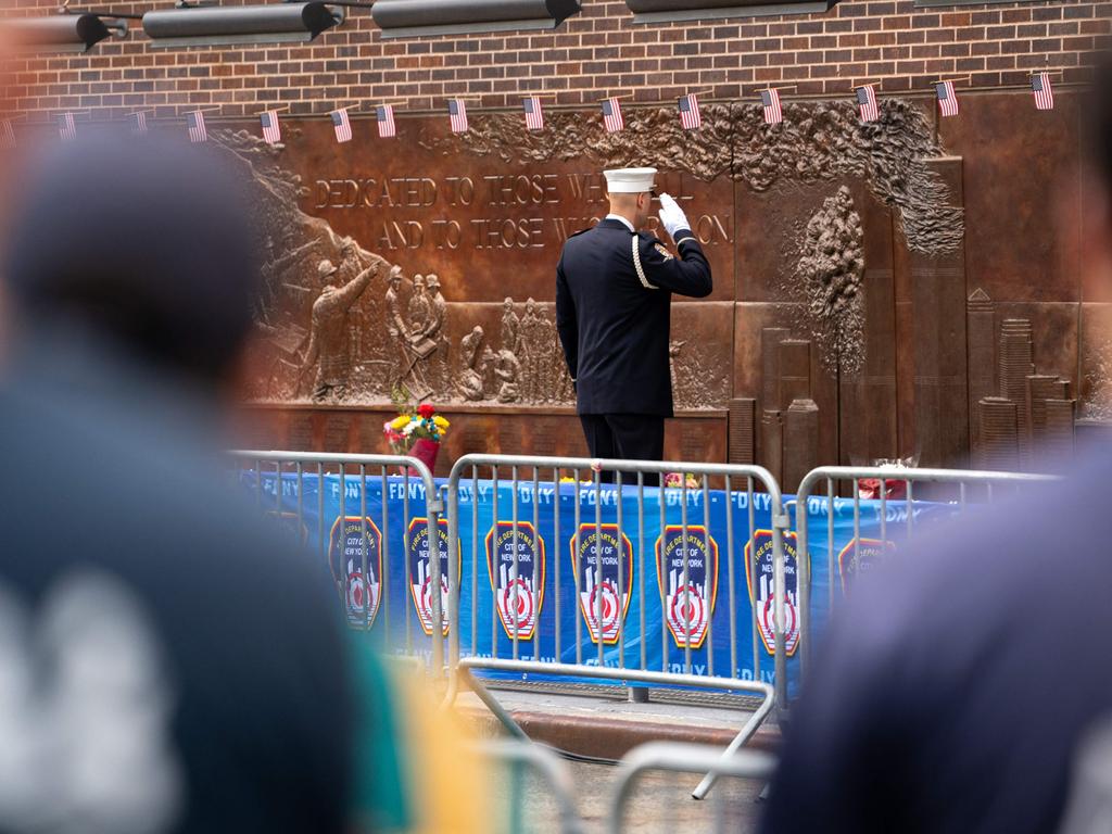 A fireman salutes the FDNY memorial wall honouring the lives of those lost in the attack. Picture: AFP