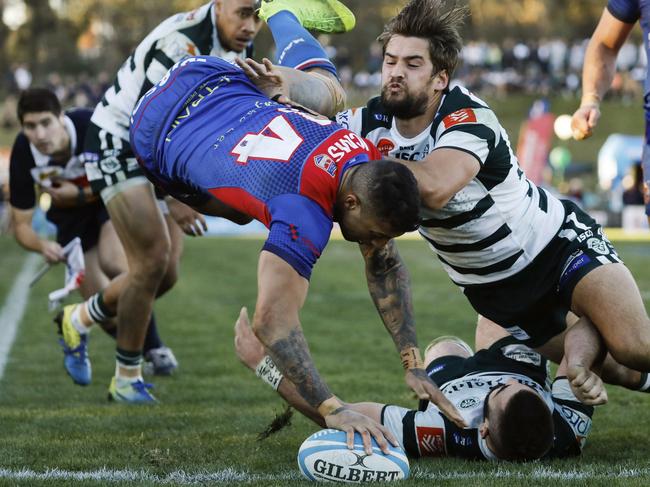 Manlyâ€™s Jay Baker leaps over Warringahâ€™s Luke Reimer to touch down as Harry Jones swoops in. Warringah v Manly (Northern Beaches Derby 2), Shute Shield Rd 16 at Pittwater Rugby Park. Rats def Marlins 28-23. Saturday 20th July 2019.  Â© Karen Watson