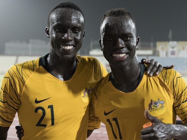A supplied image obtained on Tuesday, October 16, 2018, shows Socceroo players Thomas Deng and Awer Mabil shortly after Monday's match in Kuwait. South Sudanese refugees and childhood friends Awer Mabil and Thomas Deng have made their Socceroos debuts together in Australia's 4-0 defeat of Kuwait. (AAP Image/Football Federation Australia, Tristan Furney) NO ARCHIVING, EDITORIAL USE ONLY