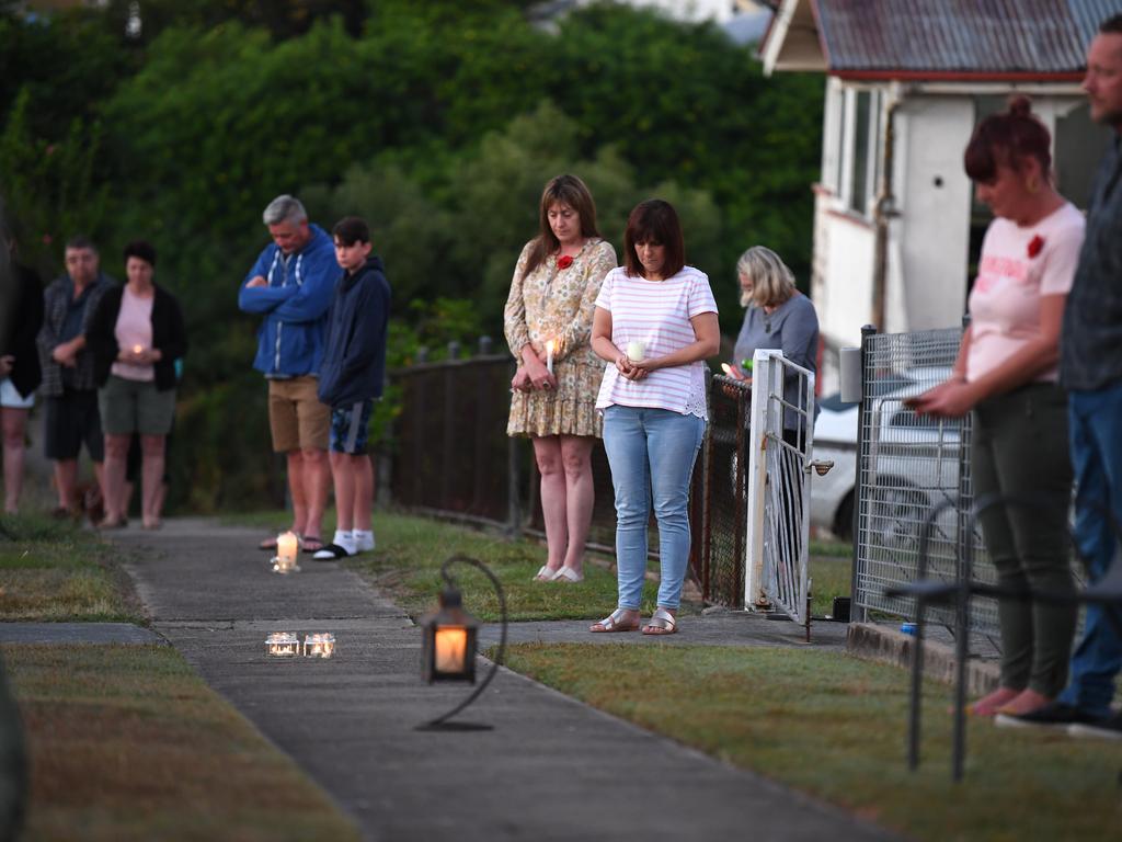 People stand outside their homes at dawn to commemorate Anzac Day in Brisbane, Saturday, April 25, 2020. (AAP Image/Dan Peled)