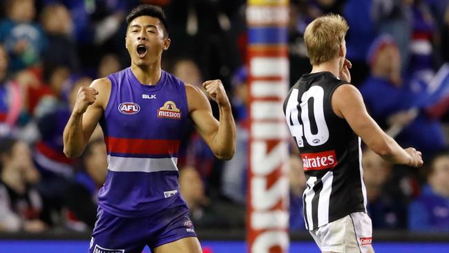 Lin Jong celebrates a goal against Collingwood.