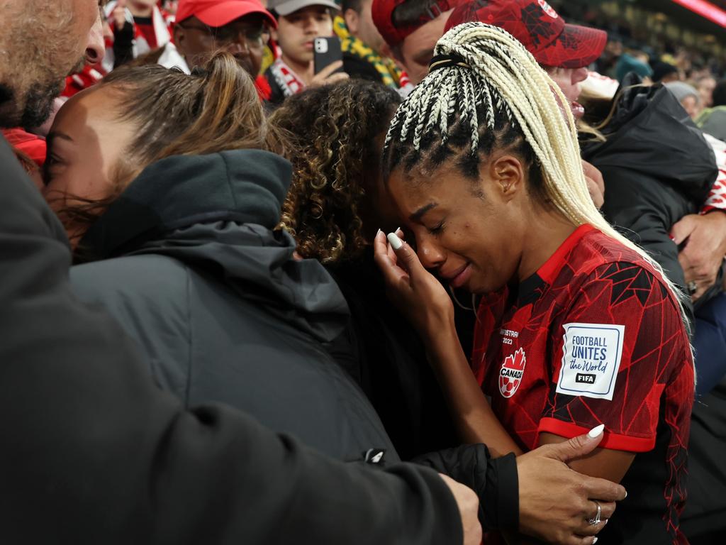 Ashley Lawrence of Canada is consoled by her family after the team's defeat and elimination from the tournament against Australia. Picture: Alex Grimm/Getty Images