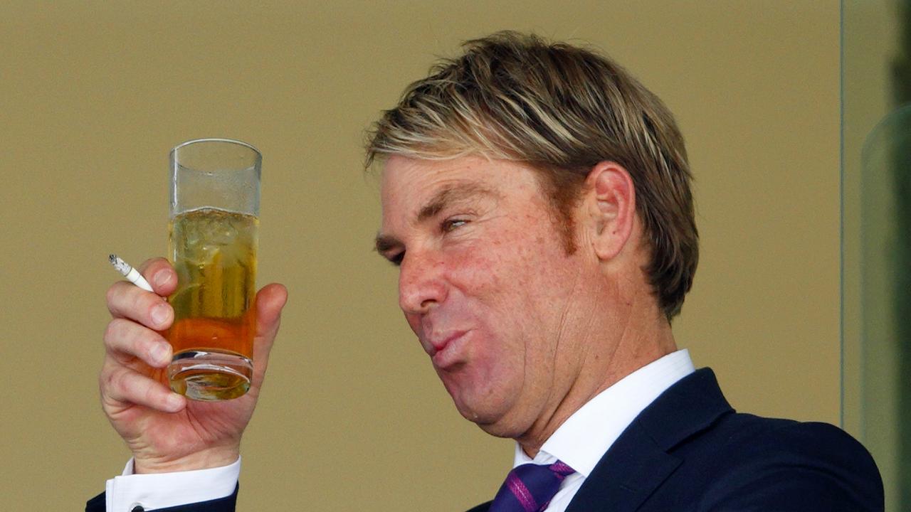 Shane Warne enjoys a beer at the races in the UK.