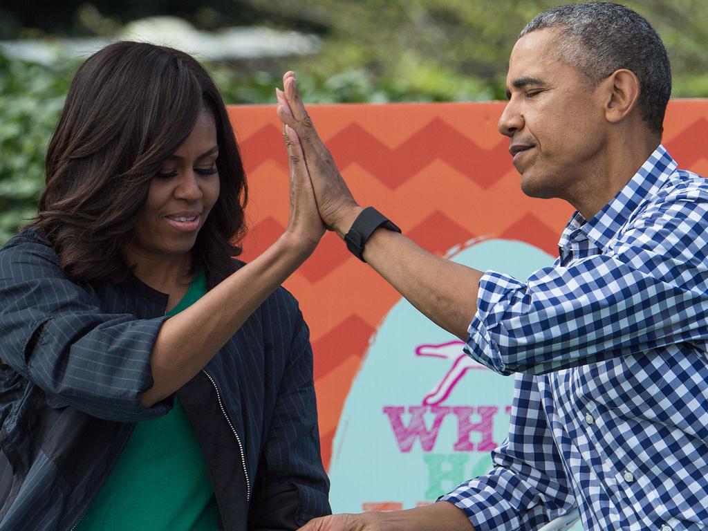 US President Barack Obama and First Lady Michelle Obama high five each other after reading Maurice Sendak's Where the Wild Things Are to children at the annual Easter Egg Roll at the White House in Washington, DC in 2016. Picture: AFP