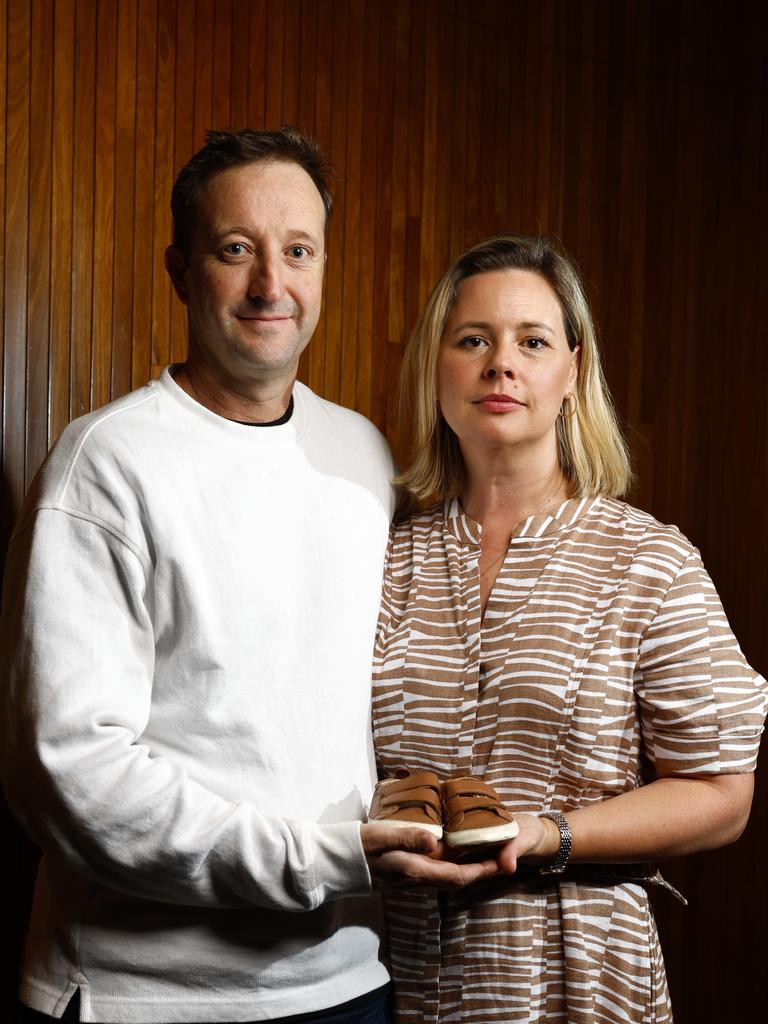 Elouise and Danny Massa, holding the shoes of their two-year-old son Joe. Picture: Jonathan Ng