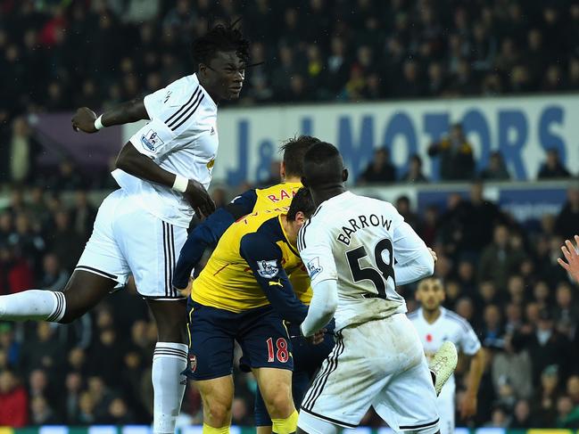 SWANSEA, WALES - NOVEMBER 09: Swansea player Bafetimbi Gomis (c) heads the second Swansea goal during the Barclays Premier League match between Swansea City and Arsenal at Liberty Stadium on November 9, 2014 in Swansea, Wales. (Photo by Stu Forster/Getty Images)