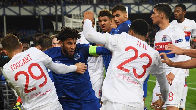 Ashley Williams of Everton (2L) clashes with Lyon players after a challenge on Anthony Lopes.