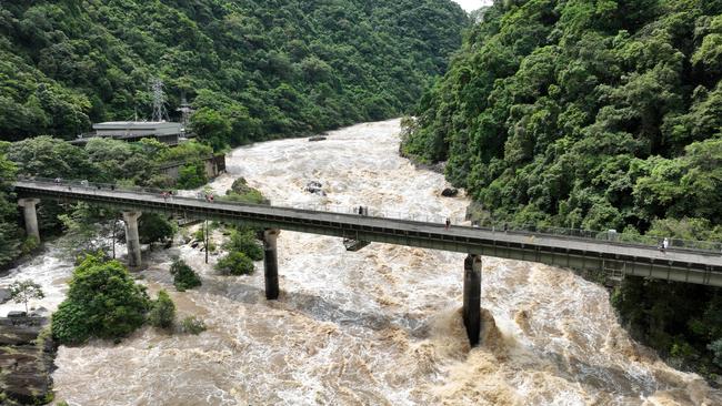 Heavy rain falls in Far North Queensland has seen a huge amount of water flow into the rivers and creeks around Cairns. The Barron River is a raging torrent of water near the hydro electricity plant in the Barron Gorge at Caravonica. Aerial drone picture: Brendan Radke