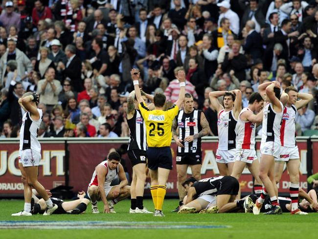 Exhausted players react on the final siren of the drawn 2010 grand final.