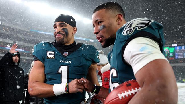 PHILADELPHIA, PENNSYLVANIA - JANUARY 19: (L-R) Jalen Hurts #1 and Saquon Barkley #26 of the Philadelphia Eagles react after defeating the Los Angeles Rams 28-22 in the NFC Divisional Playoff at Lincoln Financial Field on January 19, 2025 in Philadelphia, Pennsylvania. Sarah Stier/Getty Images/AFP (Photo by Sarah Stier / GETTY IMAGES NORTH AMERICA / Getty Images via AFP)