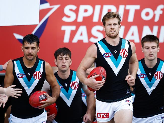 HOBART, AUSTRALIA - MAY 13: Tom Jonas of the Power leads his team on to the field during the 2023 AFL Round 09 match between the North Melbourne Kangaroos and the Port Adelaide Power at Blundstone Arena on May 13, 2023 in Hobart, Australia. (Photo by Dylan Burns/AFL Photos via Getty Images)