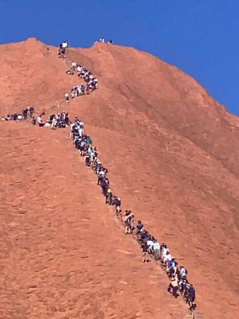 Tourists climbing up Uluru on Monday. Picture: Glenn Minett