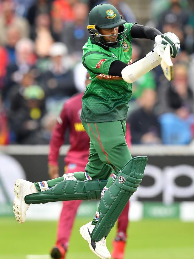 Bangladesh's Shakib Al Hasan jumps as he plays a shot. Picture: Saeed Khan/AFP