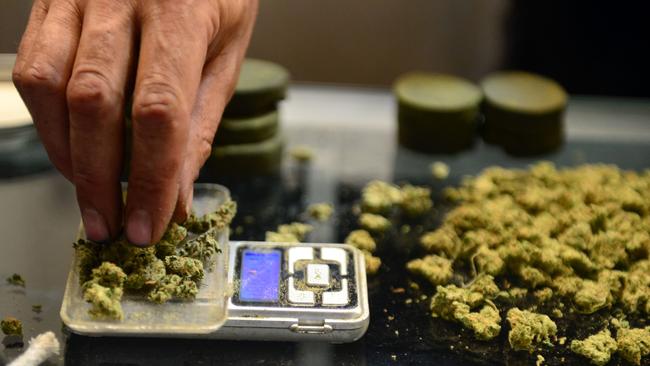 A vendor weighs marijuana buds at Los Angeles' first cannabis farmer's market, in 2014 when it was allowed for medical use. Picture: AFP