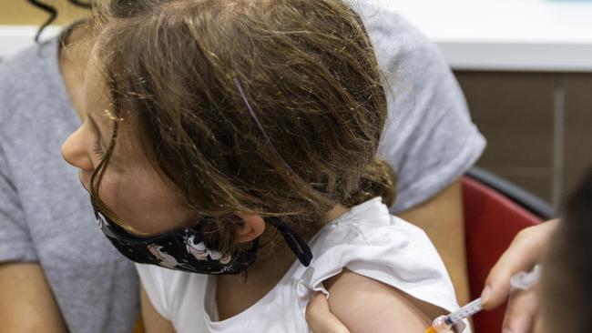 Registered nurse Emma Ahearn administers the Pfizer COVID-19 vaccine to Millie Persic sitting on the lap of mother Maria Persic at Sydney Road Family Medical Practice in Balgowlah on January 11. Picture: Jenny Evans/Getty Images