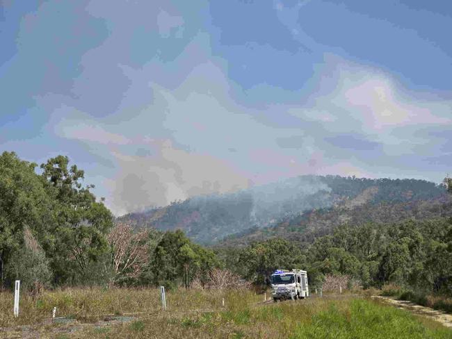 Emergency services at the scene of multiple fires on Mount Morgan range on September 22, 2024. SES have road blocks on the Burnett Hwy as Queensland Fire Brigade crews battle the fires, including using a helicopter to drop water from the air.