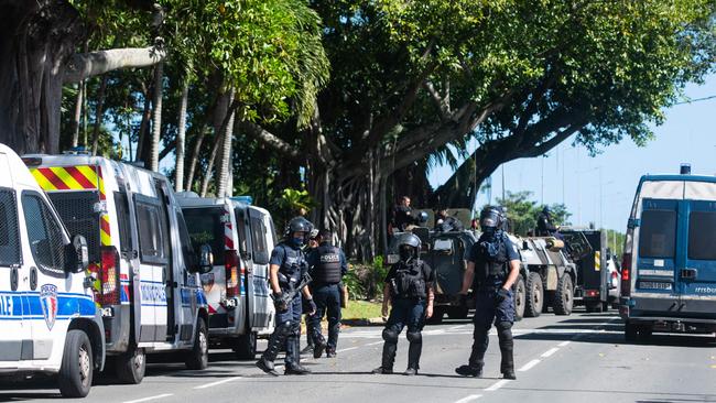 Police in riot gear are seen outside a police station in Noumea. Picture: Delphine Mayeur/AFP