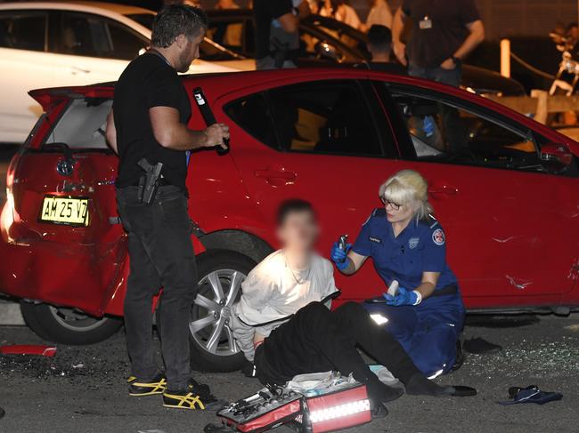 WARNING: MUST PIXELATE POLICE OFFICER WEARING THE BLUE T-SHIRT. HE IS THE OFFICER IN CHARGE... At around 9:20 pm Specialist Police were observed to perform a dramatic arrest of two men driving red toyota Yaris. Its believed that the car was forced off the road by Police Vehicles during a targett3ed operation. The car ended up crashing into a power pole before both men in the car were arrested and handcuffed. Police were alleged to have used flash bang devices which alerted people inside the the nearby Drummoyne Sailing Club leaving the thinking that shots had been fired and alerting 000. Both offenders received treatment for bloody faces and were transported away by ambulance in handcuffs. Picture: Gordon McComiskie