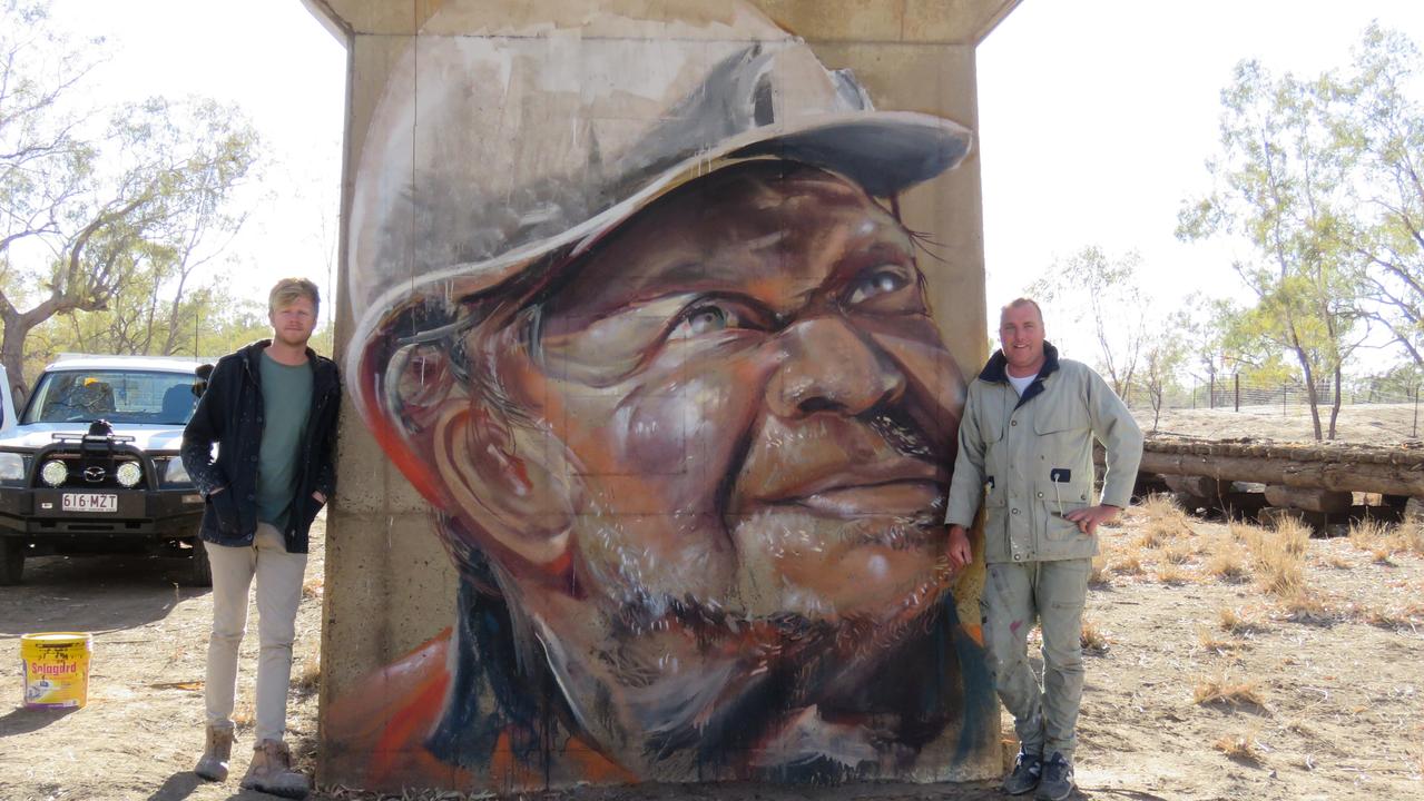 The Brisbane-based artists who painted the Thallon silos, in front of another Thallon mural. PHOTO: Gary Petrie