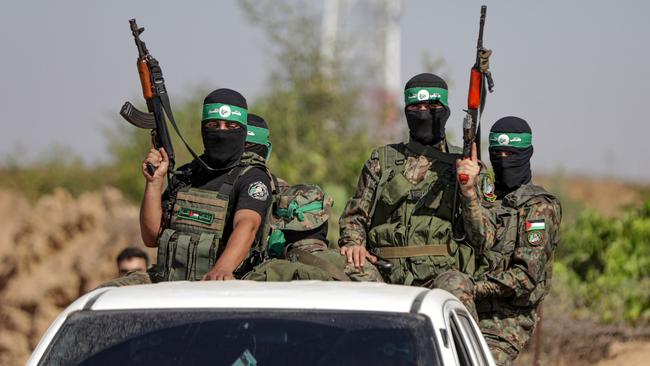 Palestinian fighters from the military wing of Hamas take part in a military parade near the border with Israel.