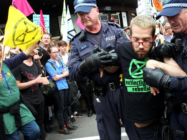 A man is arrested and hauled away by police. Picture: Getty/Lisa Maree Williams