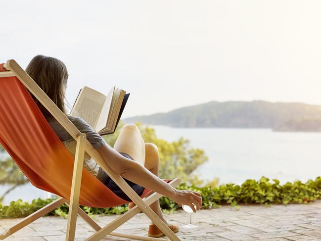 Woman reading book while relaxing on deck chair at back yardESCAPEAUGUST 30 2020NEWS & VIEWS OPINION