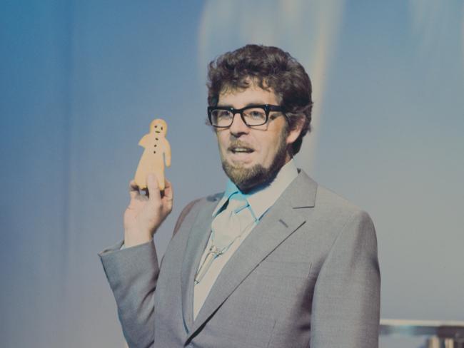 Australian entertainer Rolf Harris holding a gingerbread man during a television appearance, London, 1969. Picture: Getty Images