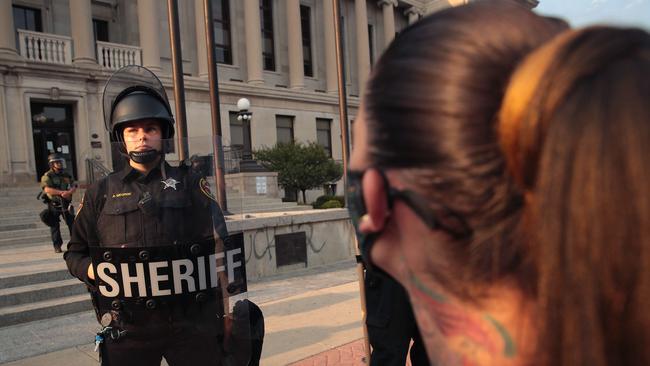 Sheriff's officers stand guard in front of the Kenosha County Court House as people protest about the shooting of Jacob Blake. Picture: Getty Images