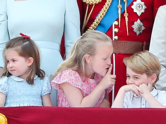 Princess Charlotte, Savannah Phillips and Prince George on the balcony of Buckingham Palace. A book claims Prince William struggled with his future role and is keeping Prince George’s life ‘normal’ for as long as possible. Picture: AFP Photo