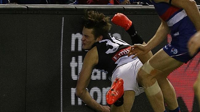 Darcy Moore crashes into the fence at Etihad Stadium. Picture: Wayne Ludbey