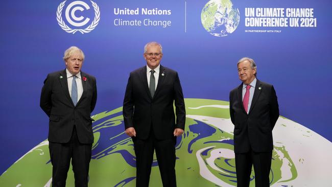 British Prime Minister Boris Johnson (L) and UN Secretary-General Antonio Guterres (R) greet Australian Prime Minister Scott Morrison as they arrive at COP26 in Glasgow, Scotland.