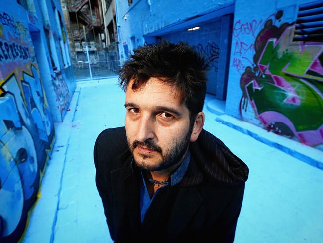 Artist Adrian Doyle in Rutledge Lane which he painted blue in 2013.