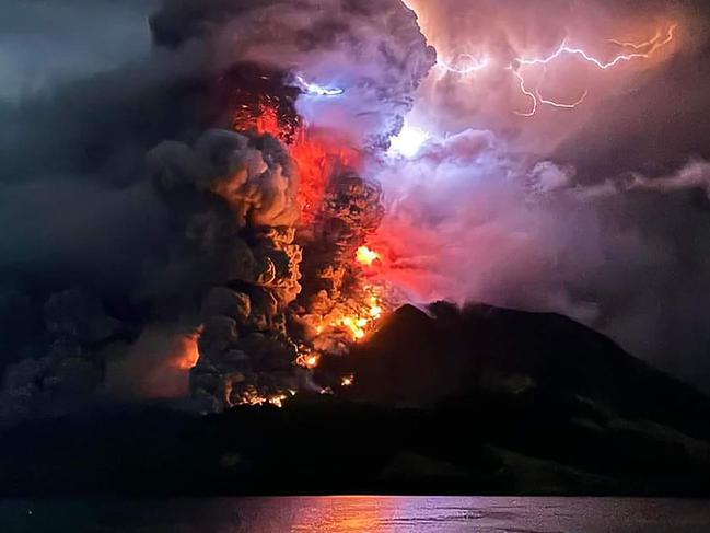 This handout photograph taken and released by the Center for Volcanology and Geological Hazard Mitigation on April 17, 2024, shows Mount Ruang spewing hot lava and smoke as seen from Sitaro, North Sulawesi. A volcano erupted several times in Indonesia's outermost region overnight on April 17, forcing hundreds of people to be evacuated after it spewed lava and a column of smoke more than a mile into the sky. (Photo by Handout / Center for Volcanology and Geological Hazard Mitigation / AFP) / RESTRICTED TO EDITORIAL USE - MANDATORY CREDIT AFP PHOTO / CENTER FOR VOLCANOLOGY AND GEOLOGICAL HAZARD MITIGATION/ PVMBK - NO MARKETING - NO ADVERTISING CAMPAIGNS- DISTRIBUTED AS A SERVICE TO CLIENTS