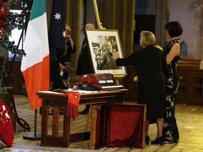 Mourners reach out to a smiling Sisto. Picture: David Caird