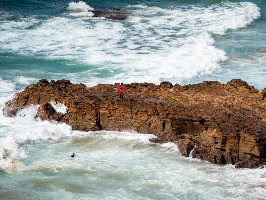 Surf rescue teams searching for Luca, who was swept off the rocks at off North Avoca. Picture: Tom Parrish