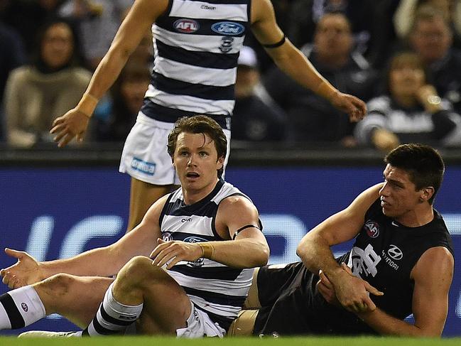 Patrick Dangerfield of the Cats (front left) and Matthew Kreuzer of the Blues (right) are seen after Dangerfield executed a tackled on the ruckman during the Round 19 AFL match between the Carlton Blues and the Geelong Cats at Etihad Stadium in Melbourne, Saturday, July 29, 2017. (AAP Image/Julian Smith) NO ARCHIVING, EDITORIAL USE ONLY