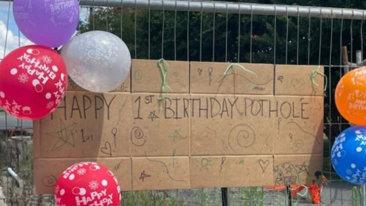 The gaping hole on Maudsley Street, Goomeri, was decorated with birthday balloons and a large birthday card after a year.