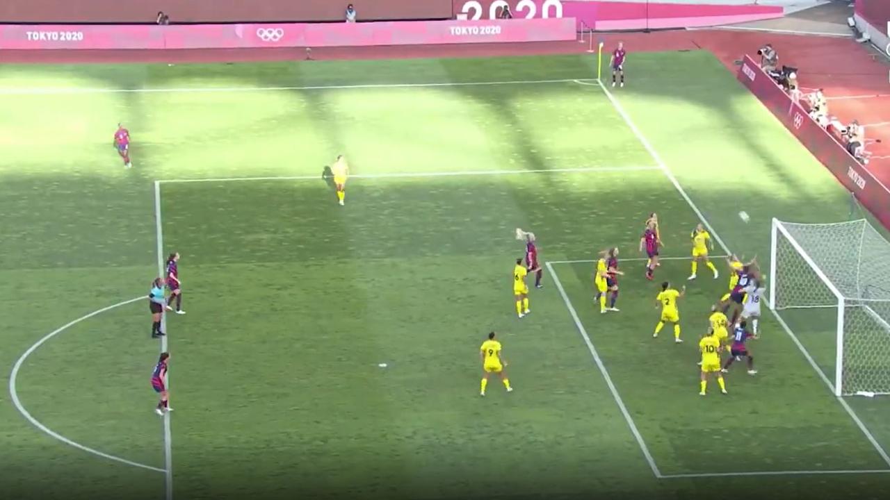 Megan Rapinoe watches on from the corner post as her shot sails in.