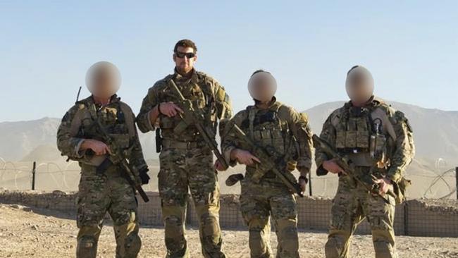 Person 11, Ben Roberts-Smith, Person 56 and Person 4 pose at Tarin Kowt in October 2012.