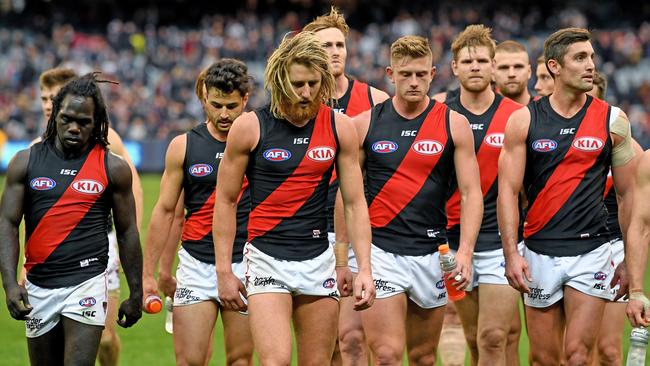 Dejected Bombers walk off the MCG after losing to Carlton.