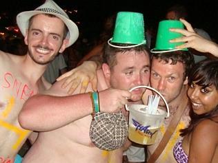 Revellers enjoy a Full Moon Party in Thailand, where the signature drink is a bucket full of alcohol with Red Bull. 