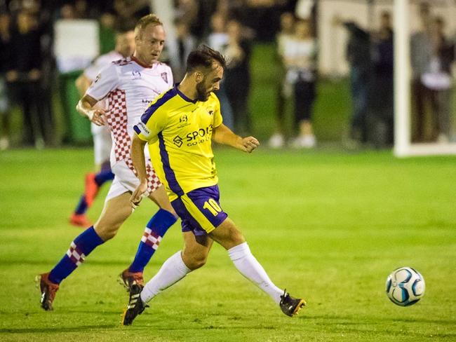 Gold Coast United's Conor Smith in action on Saturday night as Gold Coast Knights' Mitch Nichols watches on. Picture: East End Digital