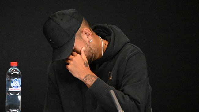 Australia's Nick Kyrgios speaks during a press conference on day one of the Australian Open tennis tournament in Melbourne on January 16, 2023. - Kyrgios pulled out of the Australian Open on January 16 without hitting a ball because of a knee injury, saying he was 