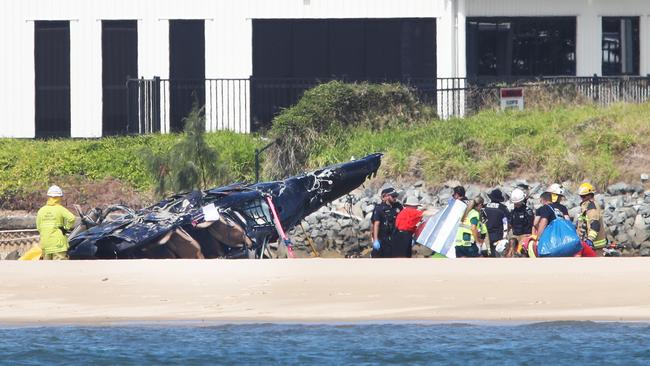 Emergency services at the scene of a Helicopter crash between two Sea World Helicopters just outside the tourist park on a sandbank in the Southport Broadwater. Picture: Glenn Hampson