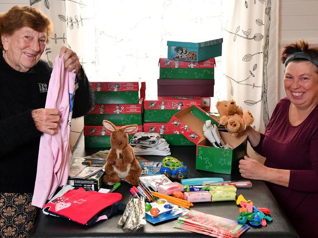 Mary Hartley and her daughter Carmel pack shoeboxes for Christmas at their Bankstown home. Picture: Joel Carrett