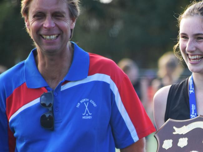 North West Sydney captain is gleeful as she accepts the NSW U18s Girl Hockey Championships division one award on behalf of her team.