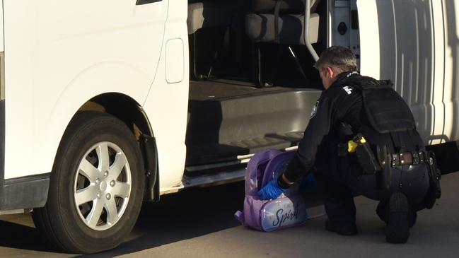 Police inspecting a bag at Gracemere's Le Smileys Early Learning Centre on Lucas Street where a three-year-old was discovered left inside the bus late Wednesday afternoon, May 4, 2022.