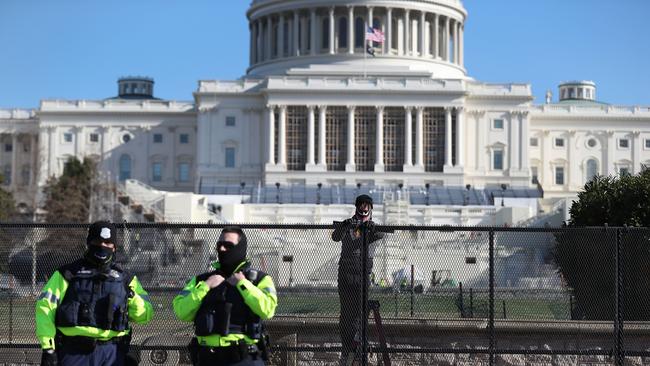 Workers erect a fence around the US Capitol Building the day after a pro-Trump mob broke into the building. Picture: Getty Images